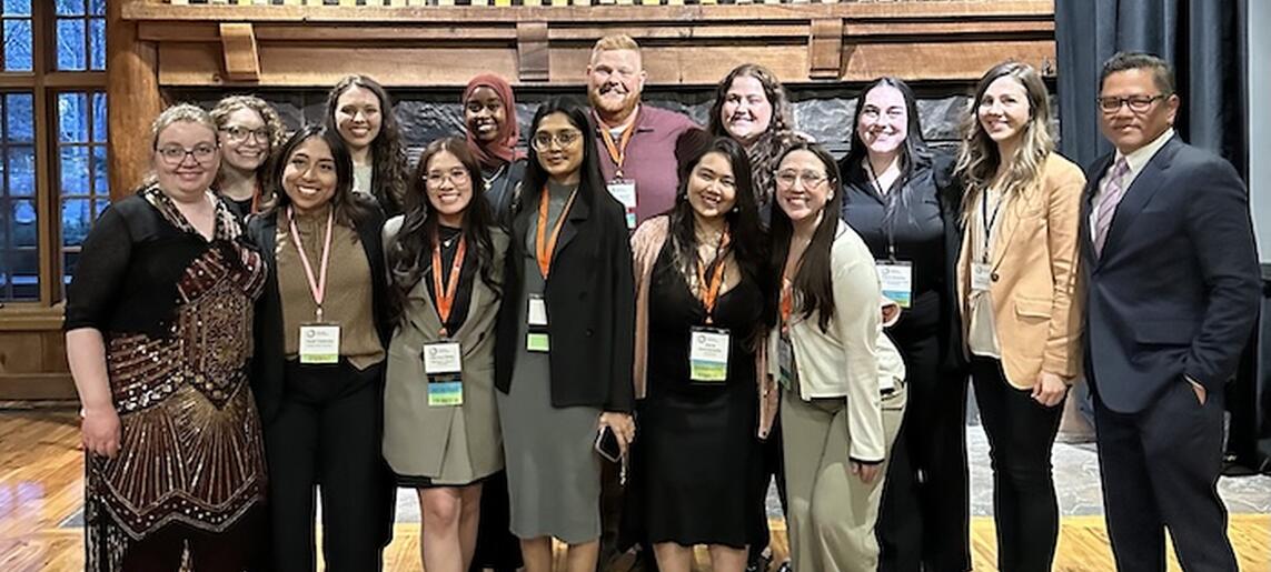 A group of students and staff smile together at oshp sunriver
