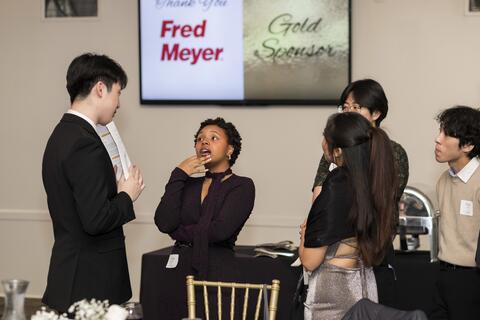 A group of people talk at a nice event
