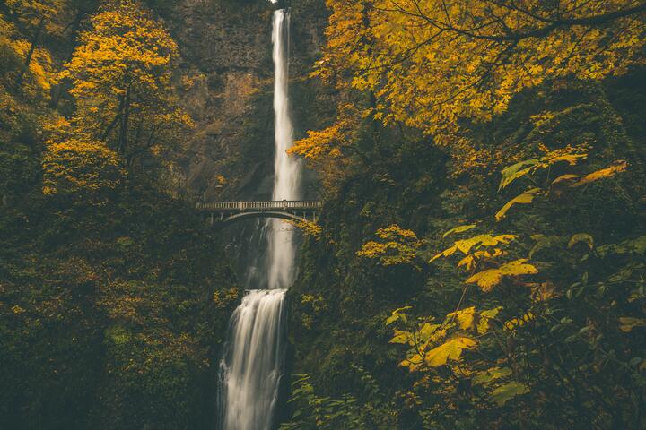 multanomah falls, a waterfall with a bridge overlooking it